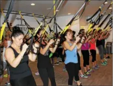  ?? DIGITAL FIRST MEDIA FILE PHOTO ?? Women use resistance bands as they do various exercises during a group fitness class. Nutrition and fitness go hand in hand. It’s important to get proper nutrients before and after a workout.