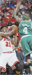  ?? Ap pHOTO ?? RISING TO OCCASION: Isaiah Thomas leaps to defend against the Bulls’ Jimmy Butler during last night’s Game 6 in Chicago.