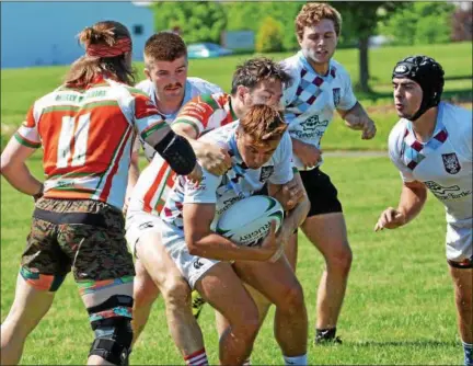  ?? DEBBY HIGH/FOR DIGITAL FIRST MEDIA ?? North Penn’s Young Bucks Tanner Visco was tackled by a host of Molly Maguires players at Saturday’s North Penn Rugby Club’s Annual 7’s Tournament.