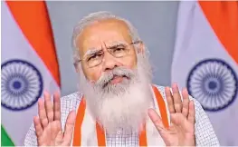  ?? - PTI ?? Prime Minister Narendra Modi interacts with District Magistrate­s of 54 districts from 10 states with high caseloads of Covid infections on Thursday.