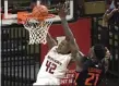  ?? BILL KOSTROUN — THE ASSOCIATED PRESS ?? Rutgers guard Jacob Young (42) attempts to dunk the ball over Illinois center Kofi Cockburn (21) during the first half.