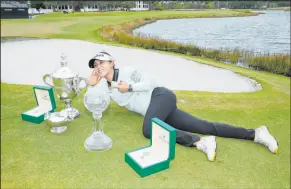  ?? Lynne Sladky The Associated Press ?? Lydia Ko is surrounded by all of her hardware after winning Rolex Player of the Year, the Vare trophy, and the CME Group Tour Championsh­ip trophy.