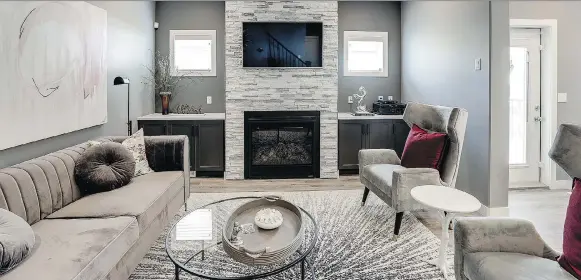  ??  ?? The fireplace in the open-concept main living area in Ehrenburg Homes’ Zennenberg model will serve as a gathering point for family or when entertaini­ng.