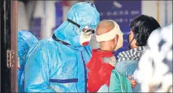  ?? RAJ K RAJ/HT PHOTO ?? A medical profession­al in full PPE gear interacts with patients at RML Hospital. n