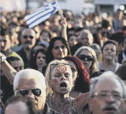 ??  ?? 0 Supporters of Greek premier Alexis Tsipras attend a 2015 rally against accepting the EU’S bailout conditions