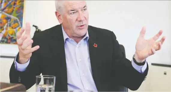  ?? JIM WELLS ?? Suncor Energy CEO Steve Williams chats with Postmedia’s Chris Varcoe in the company’s downtown Calgary office on Thursday. Williams will be leaving his post within a few days.