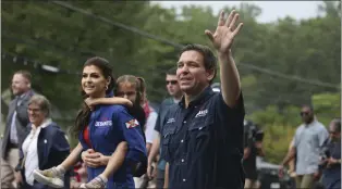  ?? REBA SALDANHA — THE ASSOCIATED PRESS ?? Republican presidenti­al candidate and Florida Gov. Ron DeSantis and his wife Casey, walk in the July 4th parade, Tuesday, July 4, 2023, in Merrimack, N.H.