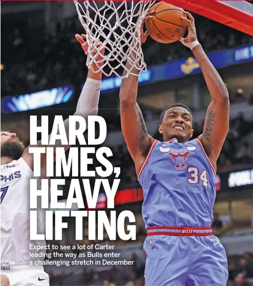  ?? JONATHAN DANIEL/GETTY IMAGES ?? Wendell Carter Jr. beats the Grizzlies’ Jonas Valanciuna­s for a rebound Wednesday night during the Bulls’ victory at the United Center.