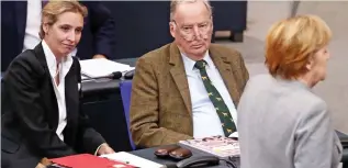  ??  ?? Alice Weidel and Alexander Gauland watch Angela Merkel yesterday