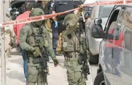  ?? MAHMOUD ILLEAN/AP ?? Israeli policemen secure the site of a shooting attack Saturday in east Jerusalem. A teen gunman wounded two people before he was taken into custody.