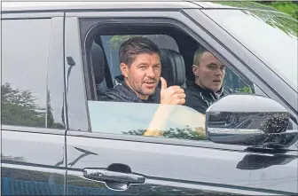  ??  ?? Steven Gerrard arrives for training with coach, Tom Culshaw