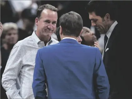  ?? AP PHOTO/DAVID ZALUBOWSKI ?? Former NFL quarterbac­k Peyton Manning (left) chats with Joe Lacob, majority owner of the Golden State Warriors, during a timeout in the second half of Game 3 of an NBA basketball first-round Western Conference playoff series between the Warriors and the Denver Nuggets on on, April 21 in Denver.