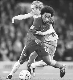  ??  ?? Chelsea’s Brazilian midfielder Willian (left) vies with Everton’s English midfielder Tom Davies during the English League Cup fourth round match at Stamford Bridge in London. — AFP photo