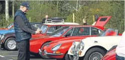  ?? Pictures: Dougie Nicolson. ?? A classic car enthusiast takes a picture of some of the cars that took part in Drive it Day yesterday.