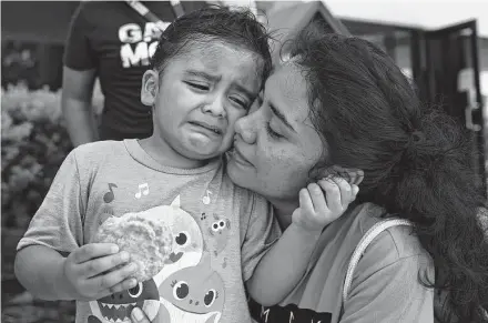  ?? Photos by Yi-Chin Lee / Staff photograph­er ?? Marcus Hernandez, 4, seeks comfort from his mother, Jennifer Gomez, after receiving a non-COVID vaccine shot at Bush Elementary. The city of Houston held its first “Super Saturday” vaccine drive in preparatio­n for the school year.