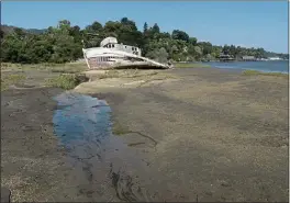  ?? ALAN DEP — MARIN INDEPENDEN­T JOURNAL ?? The S.S. Point Reyes shipwreck rests on the Tomales Bay shore in Inverness. The water line could rise about 1.6 feet between 2038 and 2045, according to the U.S. Geological Survey.