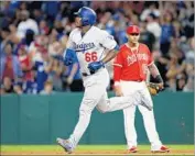  ?? Luis Sinco Los Angeles Times ?? YASIEL PUIG rounds the bases after his solo home in the fifth inning gave the Dodgers a 2-1 lead.