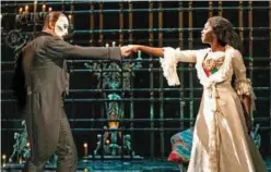  ?? Associated Press ?? Ben Crawford portrays The Phantom (left) and Emilie Kouatchou portrays Christine in a performanc­e of ‘The Phantom of the Opera’ in New York.