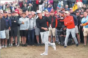  ?? PETER MORRISON / AP ?? Joint first-round leader Brooks Koepka tracks a shot out of the rough on the 15th hole during the British Open at Royal Birkdale, Southport, England on Thursday.