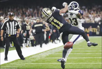  ?? GERALD HERBERT / ASSOCIATED PRESS FILE (2019) ?? New Orleans Saints wide receiver Tommylee Lewis (11) tries to catch a pass while Los Angeles Rams defensive back Nickell Robey-coleman (23) defends during the 2019 NFC championsh­ip game in New Orleans. Robey-coleman could have been cited for pass interferen­ce and helmet-to-helmet contact with 1:45 left in the fourth quarter and the game tied. Neither of the two officials nearby tossed a flag, and the Rams won 26-23.