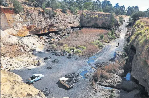  ??  ?? Jobs: An entrance to the abandoned Golfview mine in Ermelo, where bakkies load the coal brought to the surface in bags and with wheelbarro­ws. The 23-year-old informal miner (below right) supports his two children from digging and moving coal. Photos:...