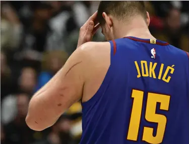  ?? ANDY CROSS — THE DENVER POST ?? Denver Nuggets center Nikola Jokic (15) with scratches and scars on his left arm during the game against the Portland Trail Blazers at Ball Arena in Denver on Friday, Feb. 2, 2024.