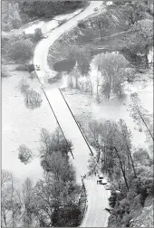  ?? Courtesy photo
/ Columbia College ?? The caption to this photo from Martin Blake's museum collection reads: “Water Over the Bridge,” a final view of historic Highway 49 Bridge over Stanislaus Canyon, hours before it disappeare­d beneath the rising waters of New Melones Dam in the first week of April 1979.”