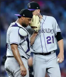  ?? / Getty Images ?? Rockies starting pitcher Kyle Freeland, right, talks with catcher Elias Diaz on the mound during the sixth inning of Thursday afternoon’s game in Miami.