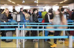  ?? NAM Y. HUH/THE ASSOCIATED PRESS ?? Travelers line up at a security checkpoint Nov. 25 at O’Hare Internatio­nal Airport in Chicago. Getting on an airplane may become more difficult because of tightened requiremen­ts.