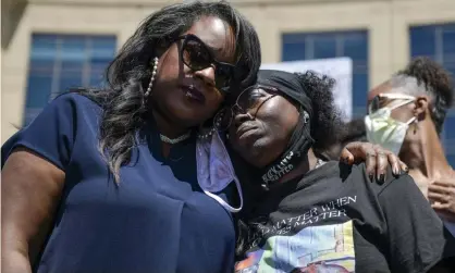  ?? Photograph: Michael Ciaglo/Getty Images ?? The Colorado state representa­tive Leslie Herod, left, hugs Elijah McClain’s mother, Sheneen McClain, right, as they stand with protesters on 27 June.