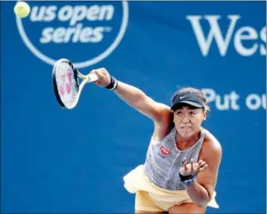  ?? ROB CARR/GETTY IMAGES/AFP ?? Naomi Osaka serves to Aliaksandr­a Sasnovich at the Western and Southern Open at Lindner Family Tennis Centre on Wednesday in Mason, Ohio.