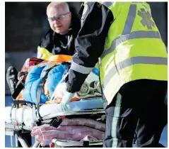  ?? JOHN LUCAS/EDMONTON JOURNAL/ FILE ?? Paramedics prepare to transport a man hurt in a Whyte Avenue collision to hospital in this photo from spring 2014.