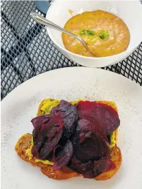  ?? STAFF PHOTO BY JENNIFER BARDONER ?? Avo Toast, as served at The Daily Ration, is an open-faced sandwich with smashed avocado, roasted beets and a sprinkling of chili-lime salt. A side of cheddar grits was a nice complement.