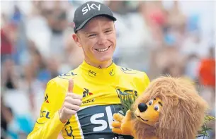  ??  ?? Chris Froome, wearing the overall leader’s yellow jersey, flashes a thumbs up on the podium after the 20th stage on Saturday.