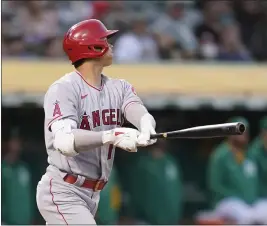  ?? JEFF CHIU — THE ASSOCIATED PRESS ?? The Angels’ Shohei Ohtani watches his two-run home run against Oakland in the second game of a doublehead­er on Saturday. It was Ohtani’s 100th major league home run.