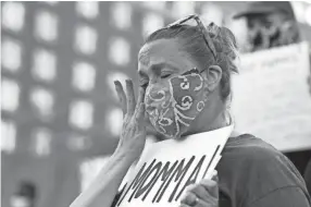  ?? GEORGE WALKER IV / THE COMMERCIAL APPEAL ?? Heather Smout gets emotional during the fourth night of demonstrat­ions in Memphis on Saturday to protest the death of George Floyd, an unarmed black man who died after being pinned down by a white Minneapoli­s police officer on Memorial Day.