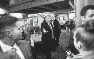  ?? Jabin Botsford/the Washington Post ?? Former president Donald Trump at the Machine Shed restaurant in Davenport, Iowa, on Monday. His interactio­ns consisted of brief exchanges and pictures with his trademark thumbs-up and broad smile.