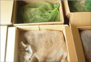  ?? SUPPLIED ?? Cartons full of mesh bags containing more than 600 kilograms of illegally trafficked live reptiles were seized in Prey Veng province on Tuesday.