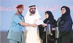  ??  ?? Shaikh Mohammad awarding Major-General Mohammad ■ Ahmad Al Merri (left), Director-General of the General Directorat­e of Residency and Foreigners Affairs, Dubai.