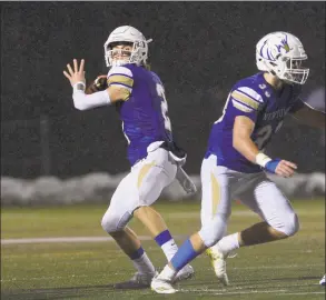  ?? H John Voorhees III / Hearst Connecticu­t Media ?? Newtown quarterbac­k Jack Street looks to pass in the Class LL state football semifinal game between No 4 Simsbury and No. 1 Newtown high schools on Dec. 9 at Newtown.