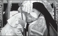  ?? AP/GREGORIO BORGIA ?? Pope Francis (left) bows to Ecumenical Patriarch Bartholome­w during a prayer Saturday at the Patriarcha­l Church of St. George in Istanbul.