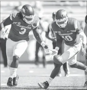  ?? NWA Democrat-Gazette/CHARLIE KAIJO ?? Arkansas defensive lineman McTelvin Agim (3) and linebacker Randy Ramsey (10) try to recover a fumble Saturday against New Mexico State at D.W. Reynolds Razorback Stadium in Fayettevil­le.