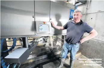  ??  ?? > Farmer James Cowan with the new robotic milking machine