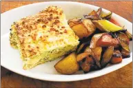  ?? J.M. Hirsch / The Associated Press ?? Matzo bread is a delicious substitute for traditiona­l pasta noodles in this rethinking of a classic lasagna — served with a side of roasted potatoes, onions and carrots.