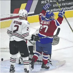  ?? ED KAISER ?? Oil Kings’ Trey Fix-Wolansky celebrates Tyler Robertson’s goal on Red Deer Rebels goalie Trevor Martin in Saturday’s season-opener. The Oil Kings were 4-3 winners in a shootout.