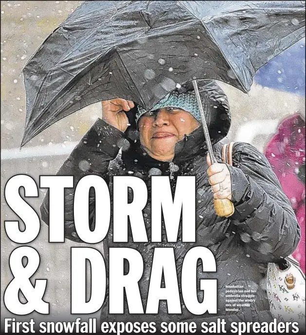  ??  ?? Manhattan pedestrian and her umbrella struggle against the wintry mix of weather Monday.