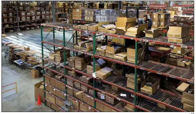  ?? AP ?? An employee moves boxes earlier this year at the Salt Lake City warehouse of Overstock.com Inc. In his resignatio­n statement Thursday, executive officer Patrick Byrne said his “presence may affect and complicate all manner of business relationsh­ips” for the company.