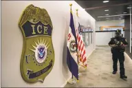  ?? Salwan Georges / The Washington Post via Getty Images ?? A law enforcemen­t officer walks past the ICE logo at the U.S. Immigratio­n and Customs Enforcemen­t headquarte­rs in Washington, D.C.