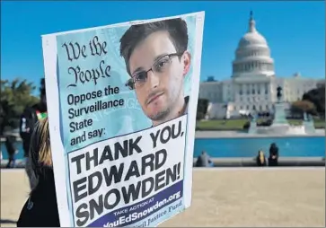  ?? Mandel Ngan AFP/Getty Images ?? IN OCTOBER 2013, a demonstrat­or supports former NSA intelligen­ce analyst Edward Snowden.