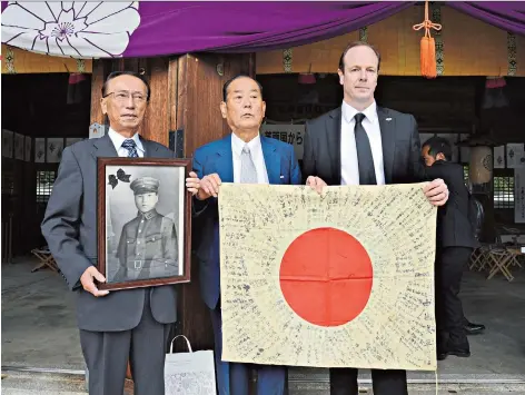  ??  ?? Reunited: Andrew Clare returns a flag to Shojiro Nakajima, above centre, whose relative died on a battlefiel­d in Burma in 1944; a ceremony is held to commemorat­e the flag returning home